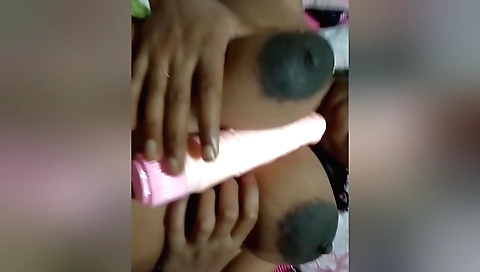 Indian hottie with big tits plays with toy on a bed