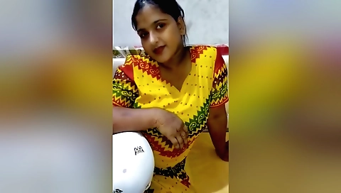 Indian brunette girl is buying clothes from a shopkeeper