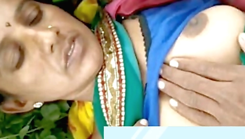 Sexy indian milf with large boobs is on the bed on her knees