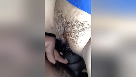 Sexy girl plays with her hairy pussy in homemade video
