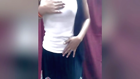 Indian teen in a red dress plays with hair and enjoys a solo