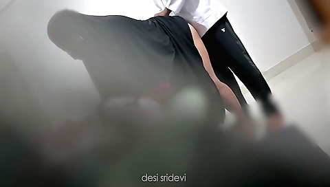 Indian woman in a hijab is wearing a pink top and white skirt