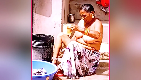 Chubby granny in a bikini shows her hairy pussy outdoors