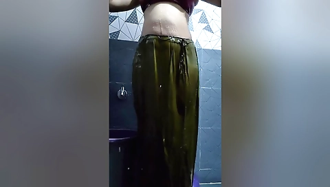 Indian teen in the bathroom is taking off her clothes